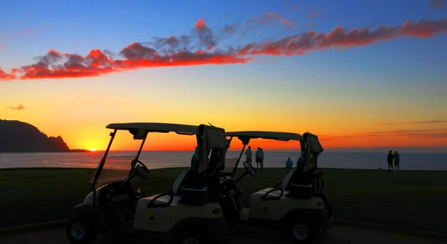 Golfers on Makai Golf Course 7th hole at sunset