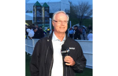 Mark Rolfing wearing NBC Golf jacket and holding mic