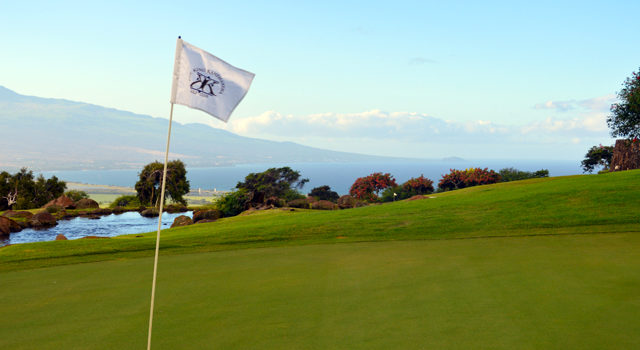 The King Kamehameha Golf Club 18th pin flag Maui coastline background